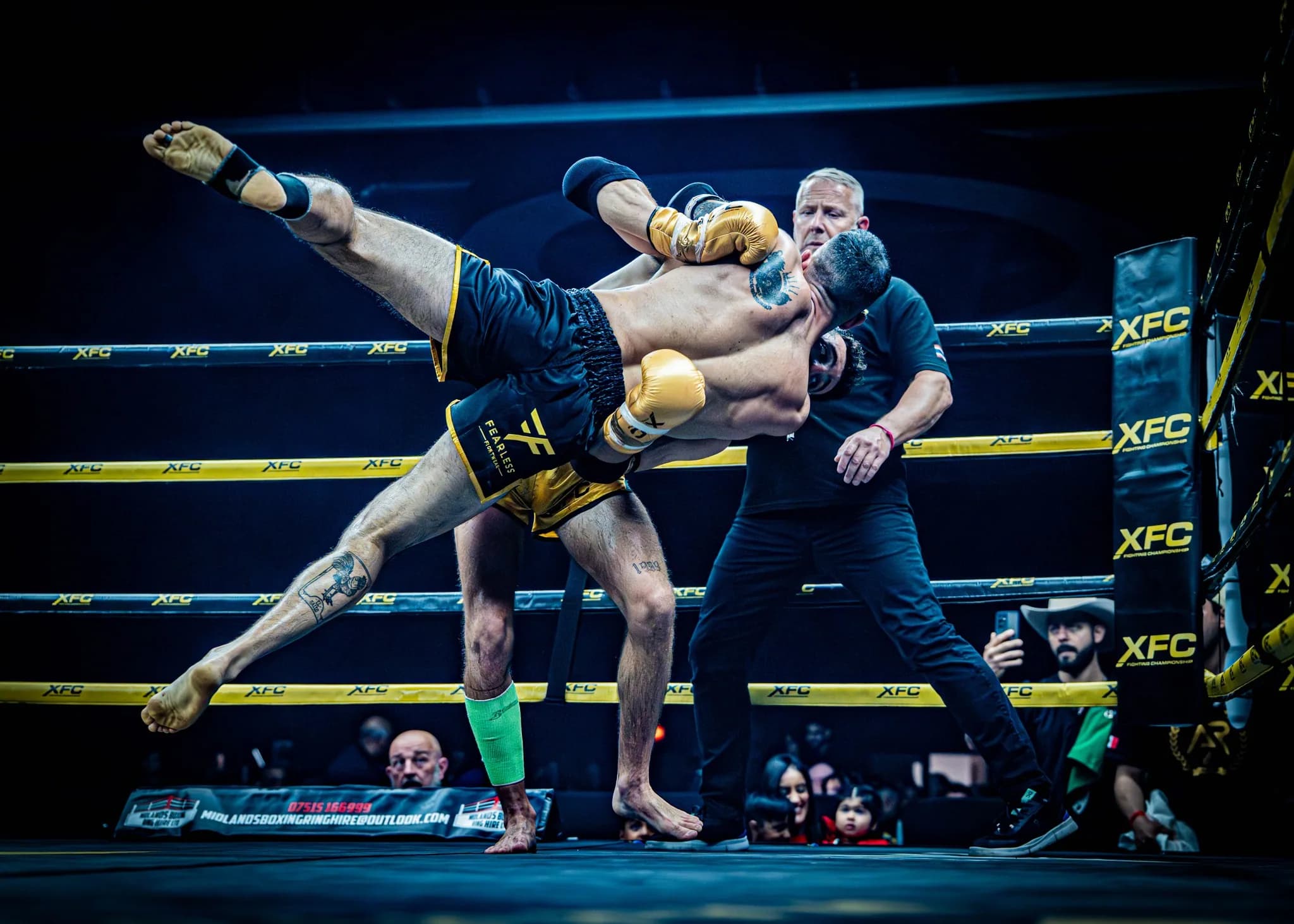 XFC fighter thrown sideways in the air during a dramatic takedown.