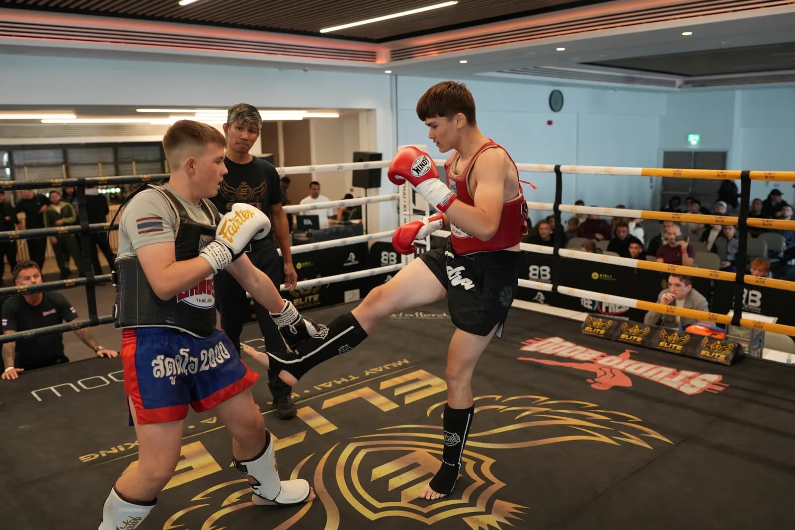XFC kickboxing image of a fighter lifting a kick during an exchange.
