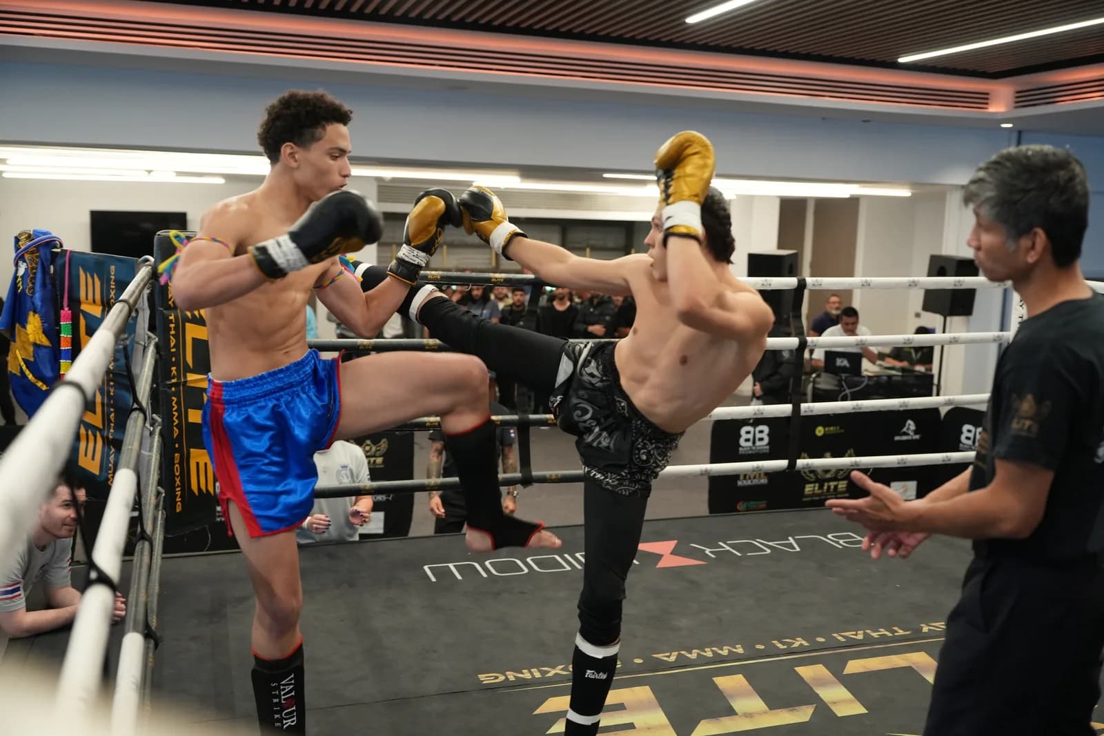 XFC fighter throwing a high kick with both athletes framed inside the ropes.
