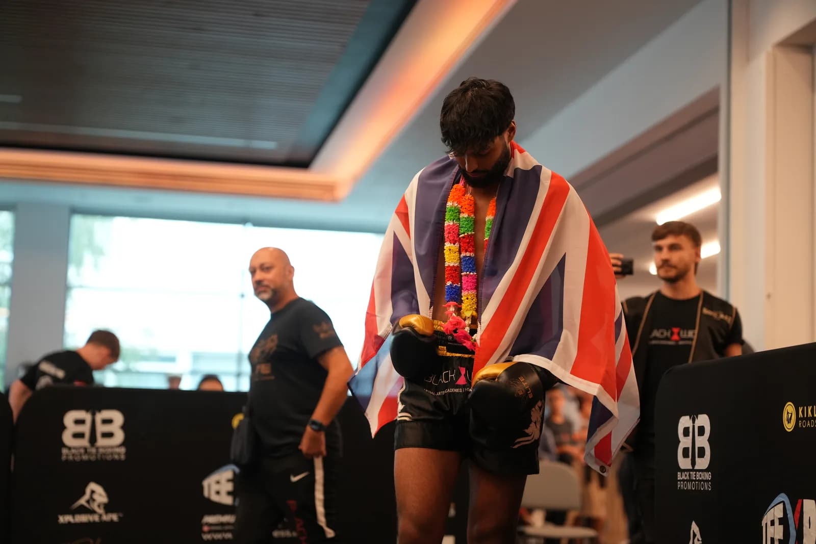 XFC post-fight image of a fighter draped in a flag after the bout.