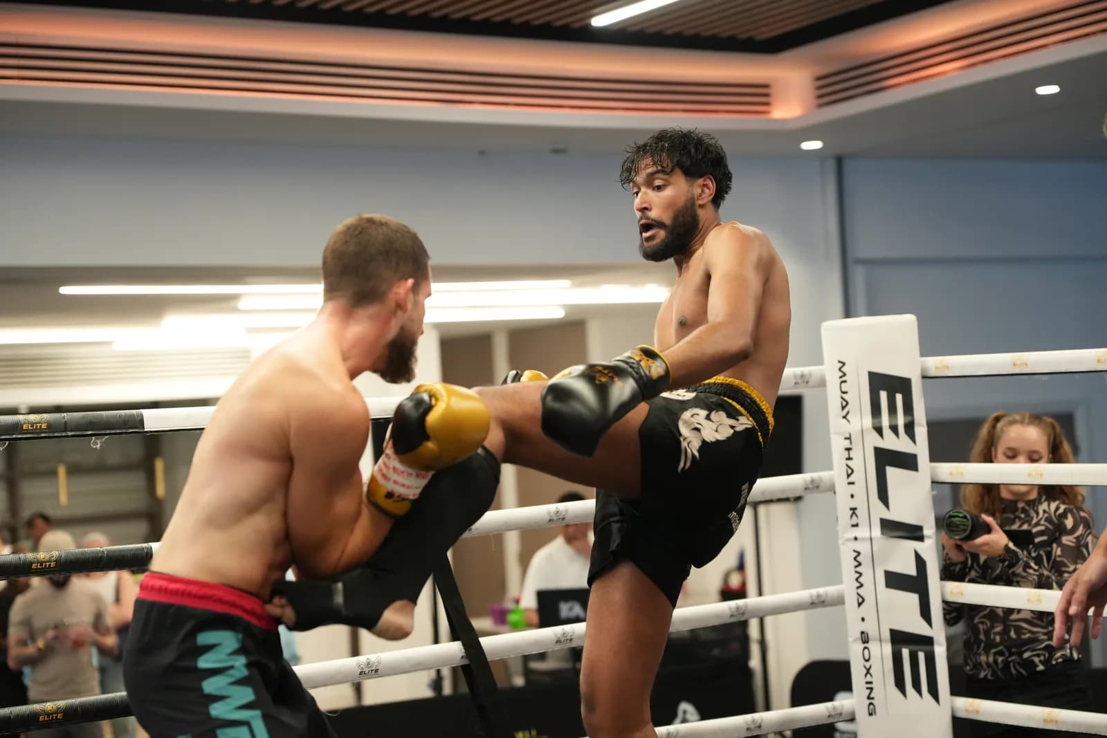 Ringside XFC image of a fighter lifting a kick in close range.