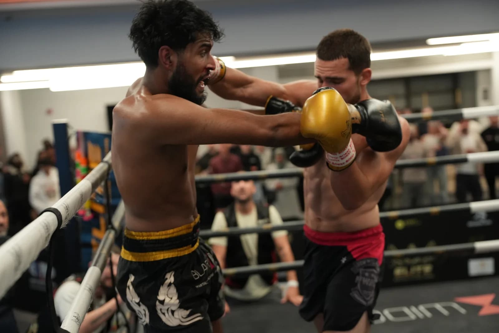 XFC boxing image capturing a punch landing cleanly at ringside.
