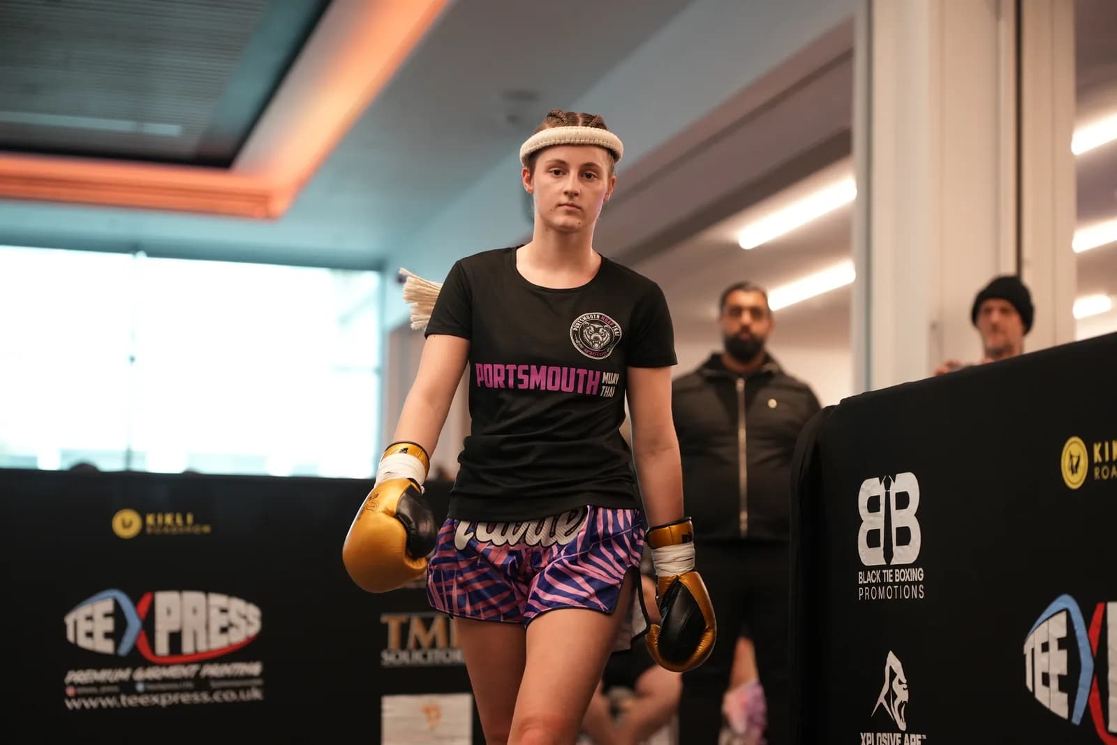 XFC fighter portrait at ringside with gloves on and sponsor boards behind.