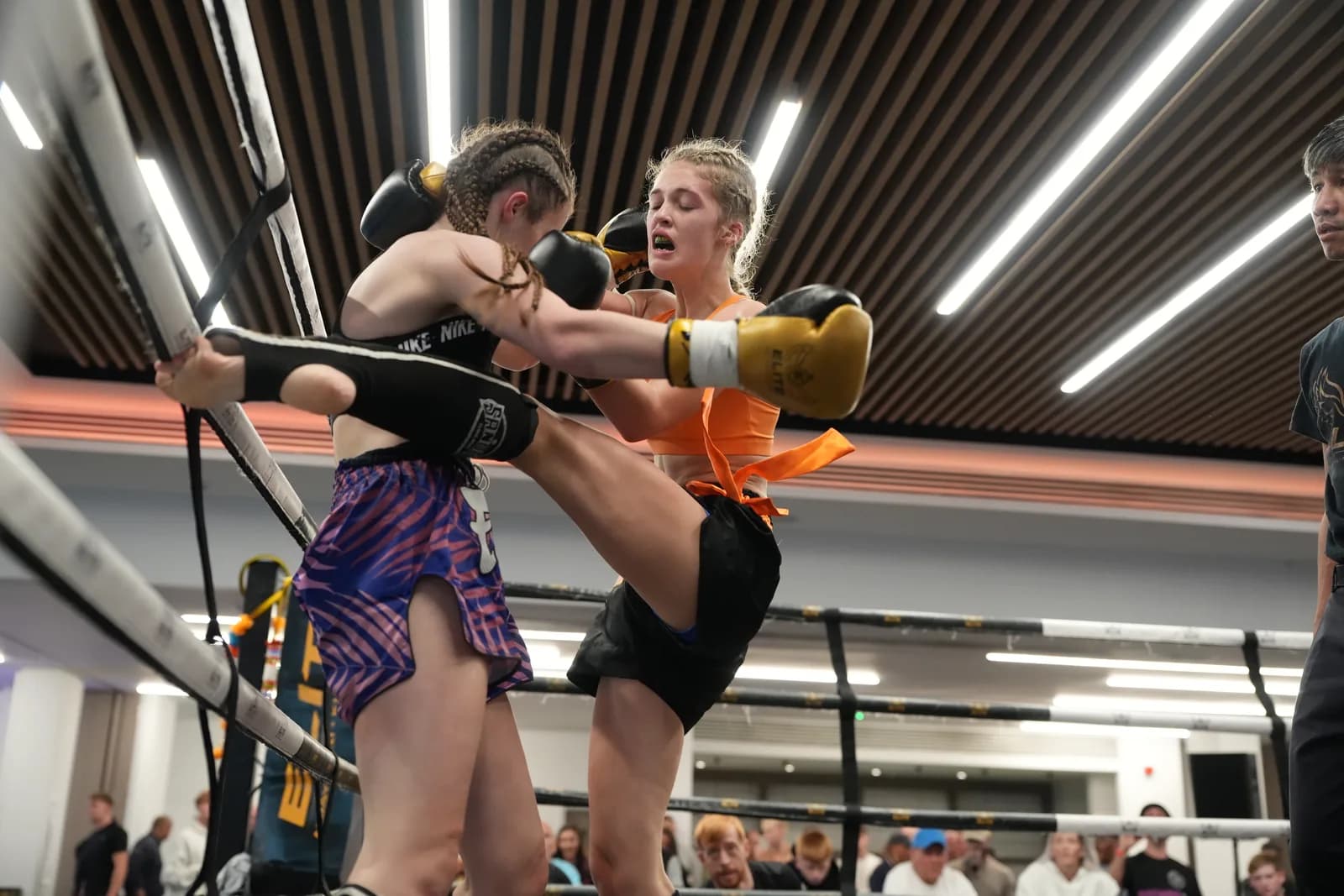 Close ringside XFC image of a kick landing during a Muay Thai exchange.