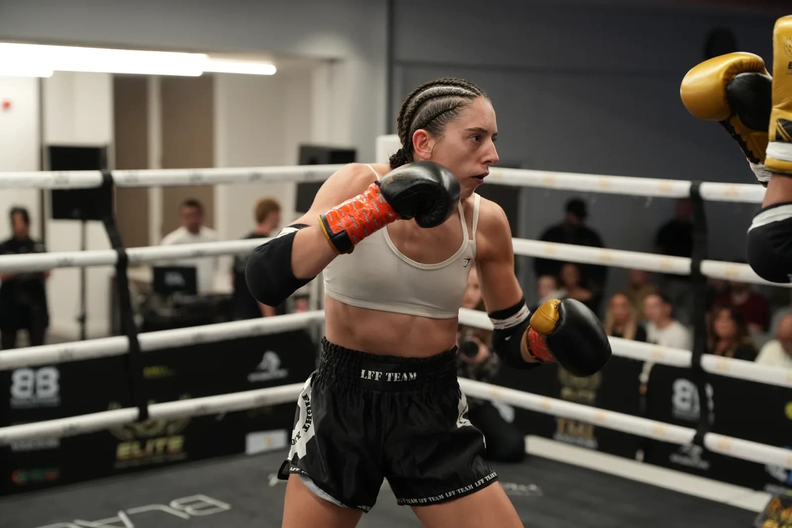 XFC fighter pressing forward with sharp focus and clean ringside separation.